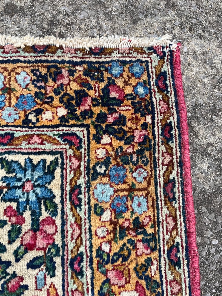 A pair of Antique Kirman mats 