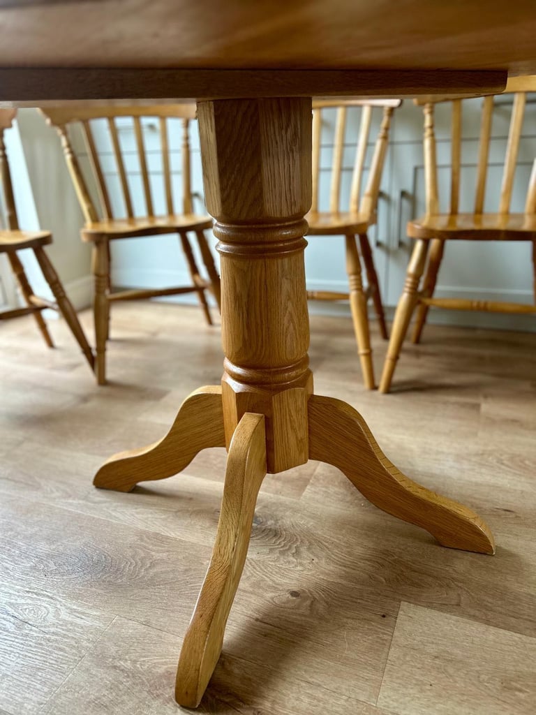 Solid oak dining table and four chairs