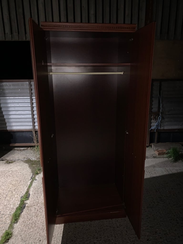 Elegant wooden wardrobe with decorative handles.