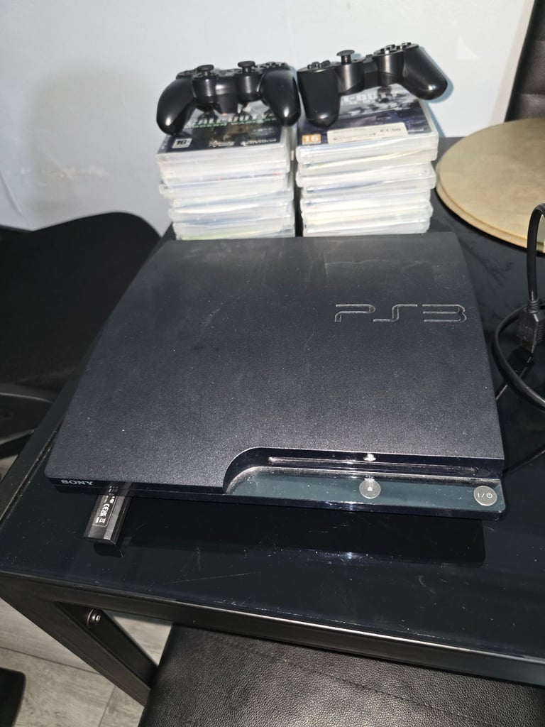 PS3 with two working controllers and 16 different disc.