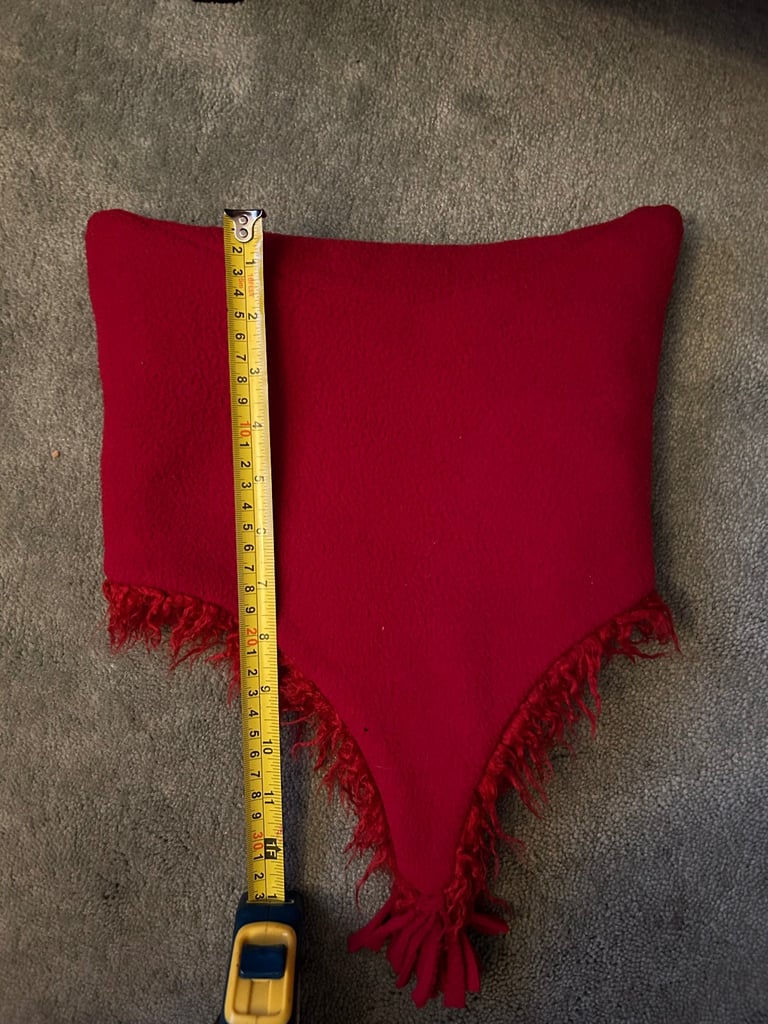 Red fuzzy fleece hat with tassels. .  