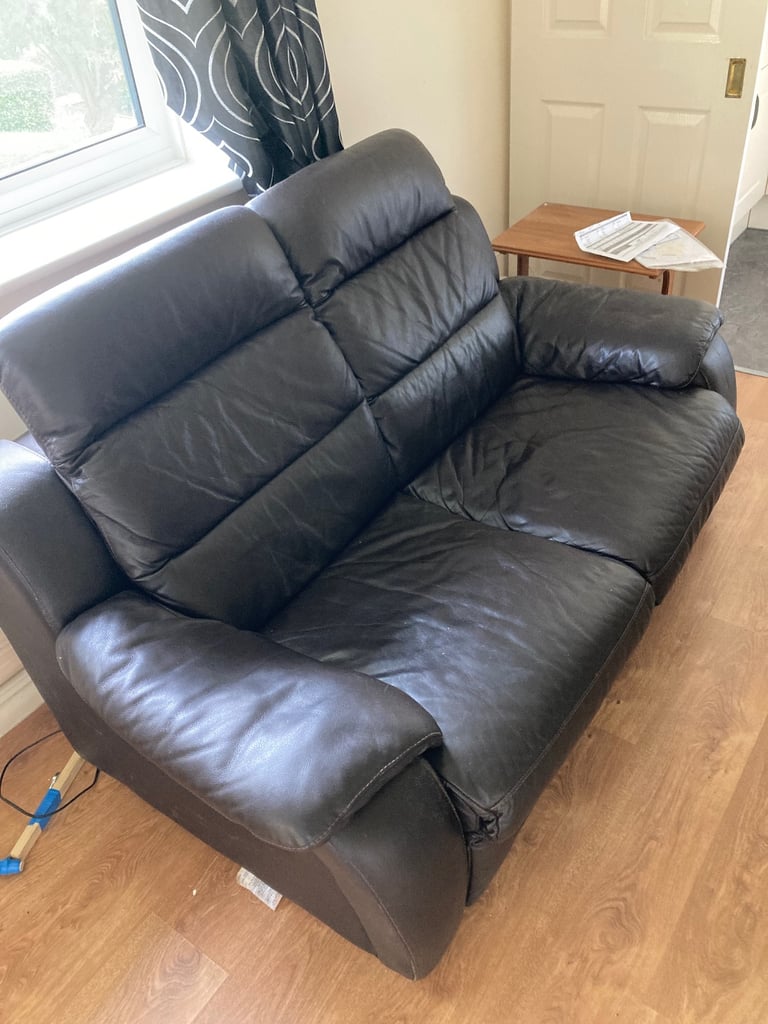 Two seater leather sofa with electric pull outs