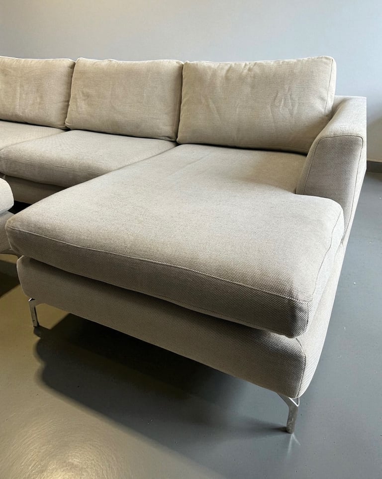 Beige corner sofa and footstool 