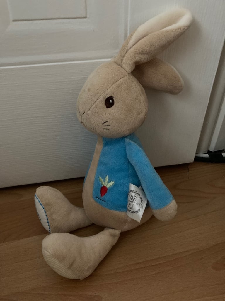 Selection of soft toys inc Peter rabbit bunny, giraffe, Winnie the Pooh and animal stacking ring