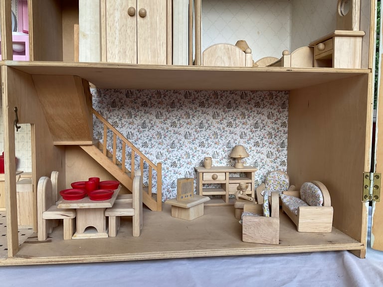 Handmade wooden dolls house with furniture and family