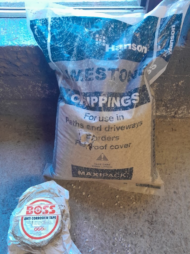 Full Roll Denso Protective Tape and Nearly Full bag Of Lime Soakaway Chippings