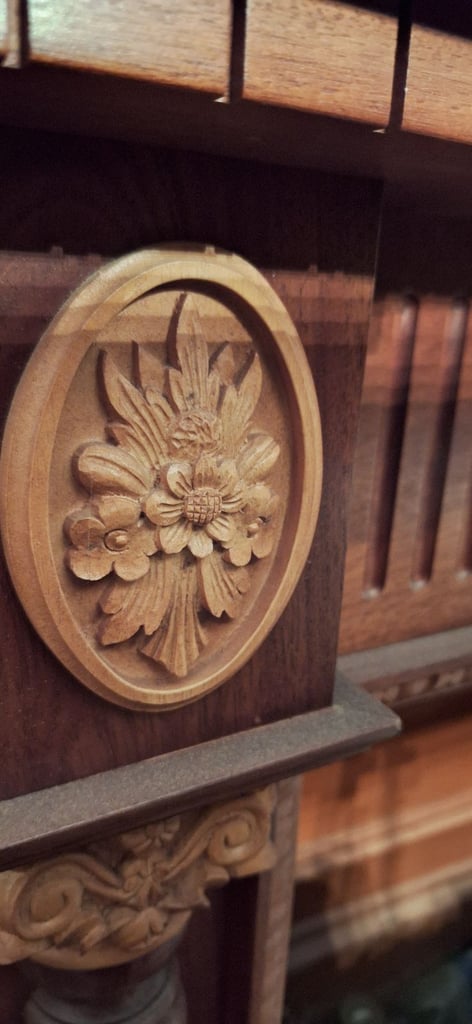 Wooden fireplace surround with carved reliefs
