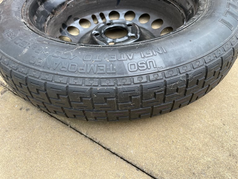 Spare tyre with toolkit