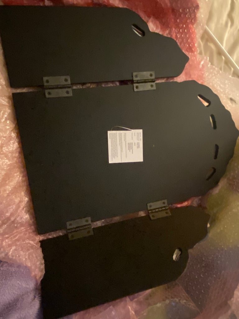 Tri-fold mirror with ornate edge 