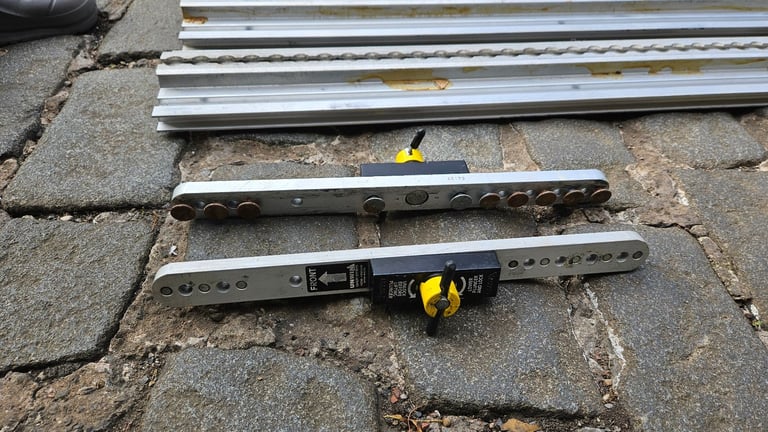 2 Unwin heavy duty floor rail tracks with clamps and end pieces.