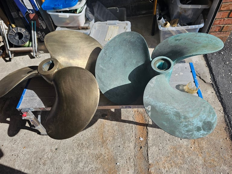 image for matching pair of Prosperous Bronze Boat Propeller. 