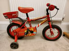 Kids red bike with stabilisers 