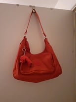 A RED/ORANGE HOBO BAG WITH MONKEY BY KIPLING IMMACULATE CONDITION. 
