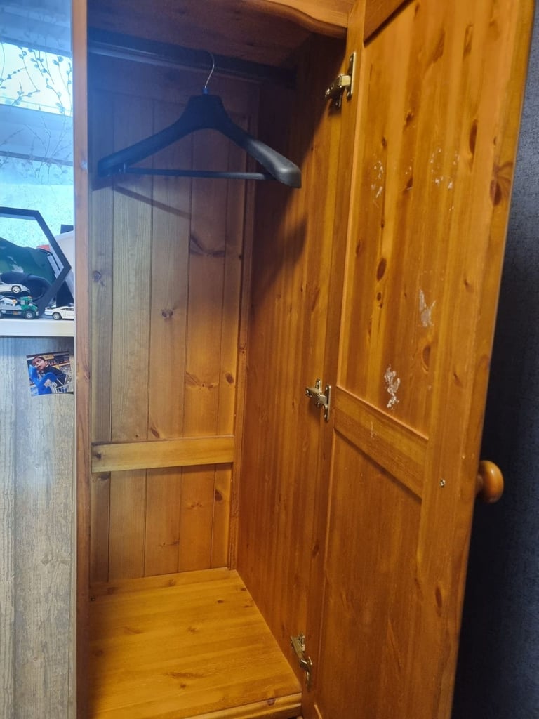 Tall slim cupboard with drawers hanging rail and separate storage 