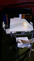 white wood oblong table with metal legs with 4 white chairs 