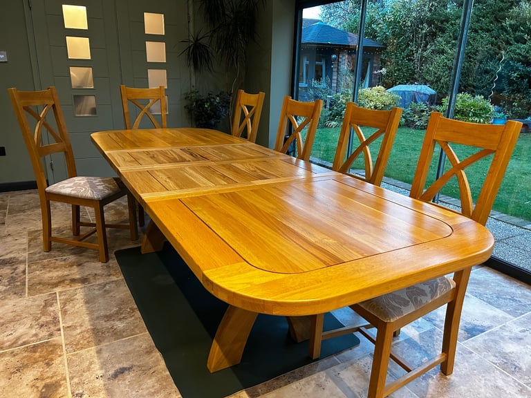 Solid oak dining table and six chairs