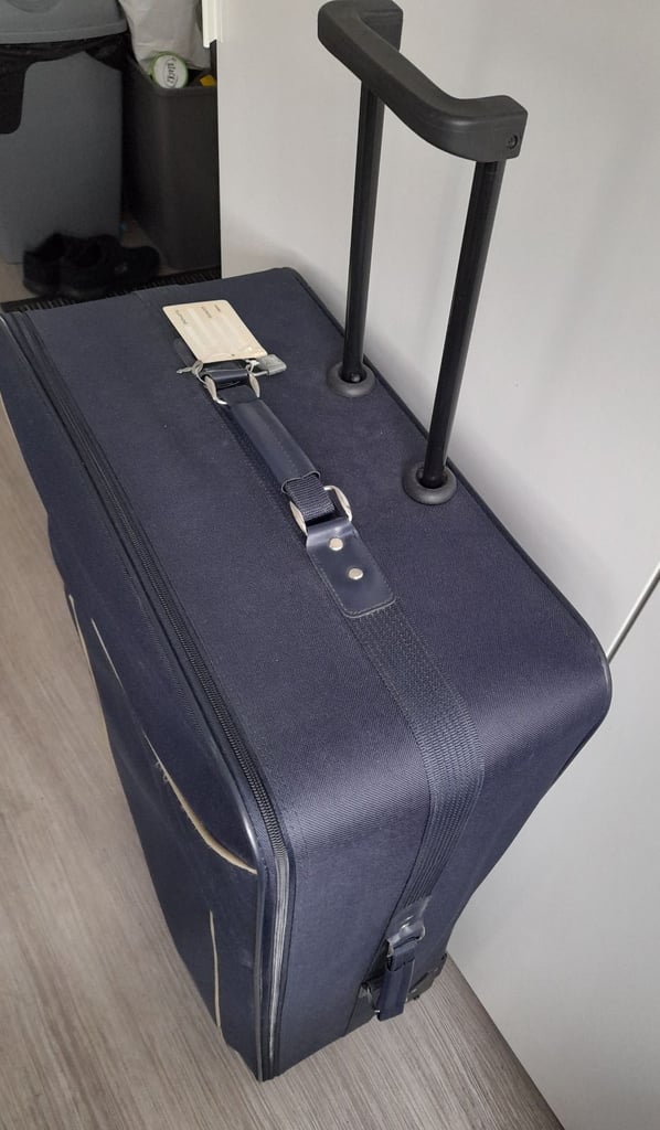 Large navy blue suitcase 32"H x 20"W x 9"D with wheels 