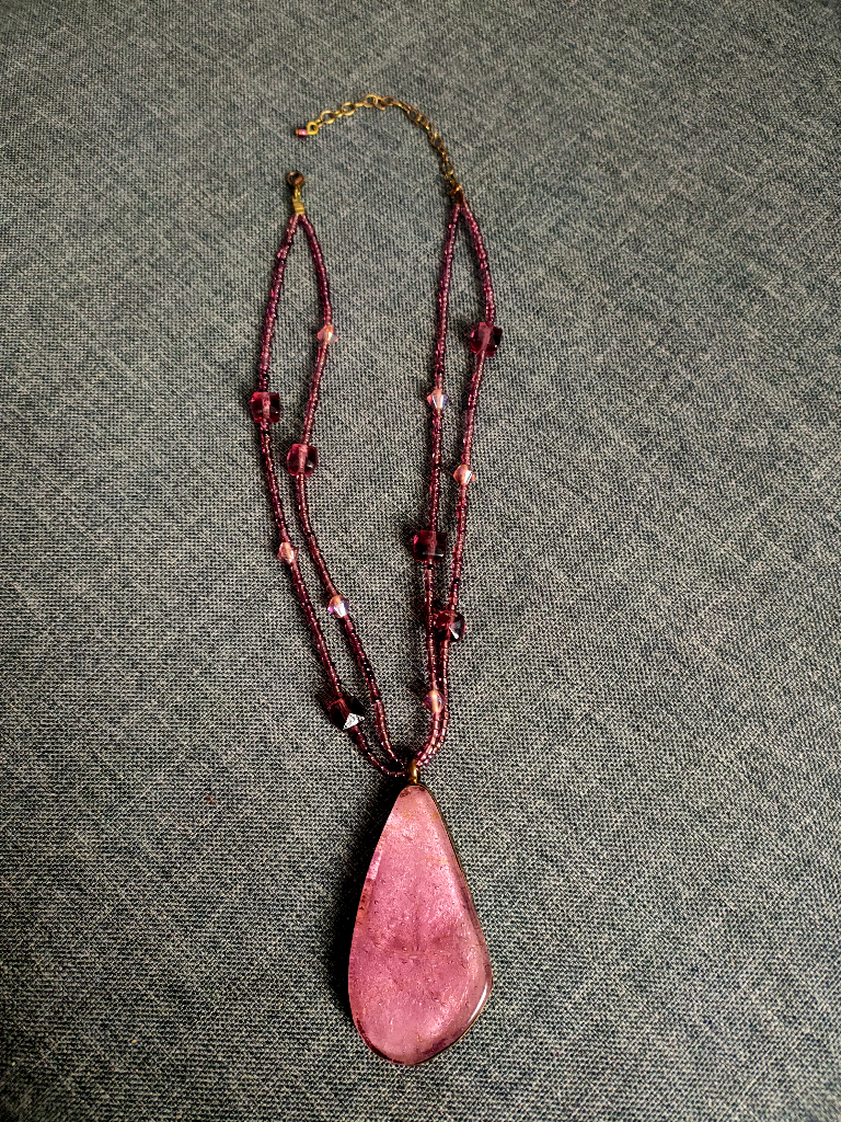 Beautiful glass pendant with glass beads set in metal (possibly copper?).