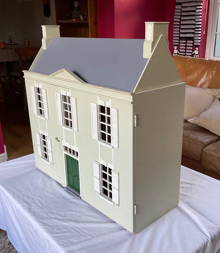 Handmade wooden dolls house with furniture and family