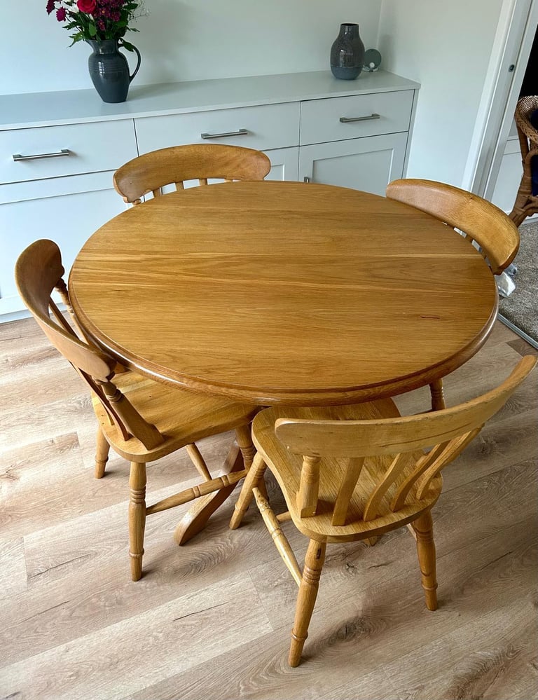 Solid oak dining table and four chairs