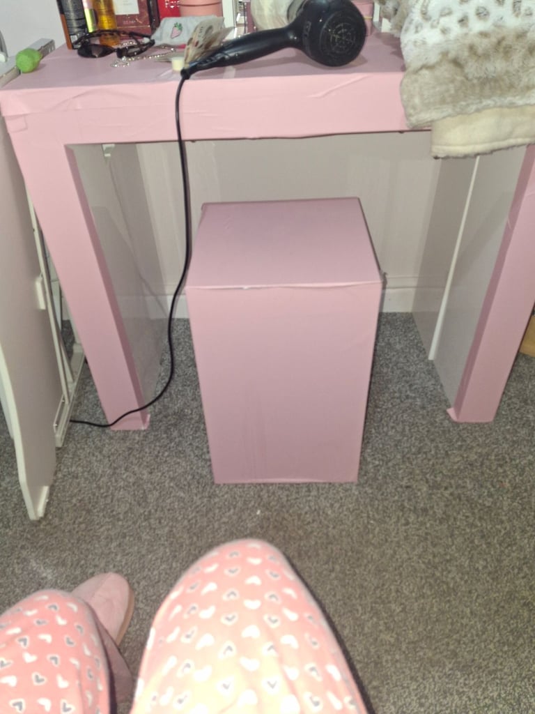 2 black arm chairs, standing up extender for desk and a pink desk with stool.