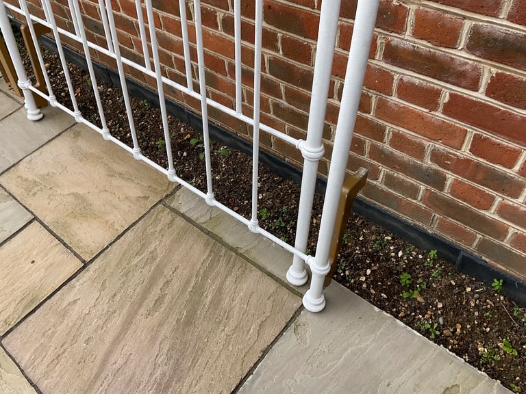 White wrought iron bedstead