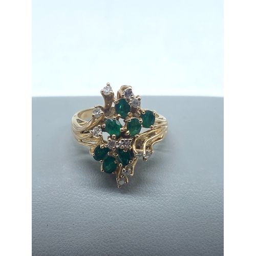 A 14ct yellow gold diamond & emerald dress ring