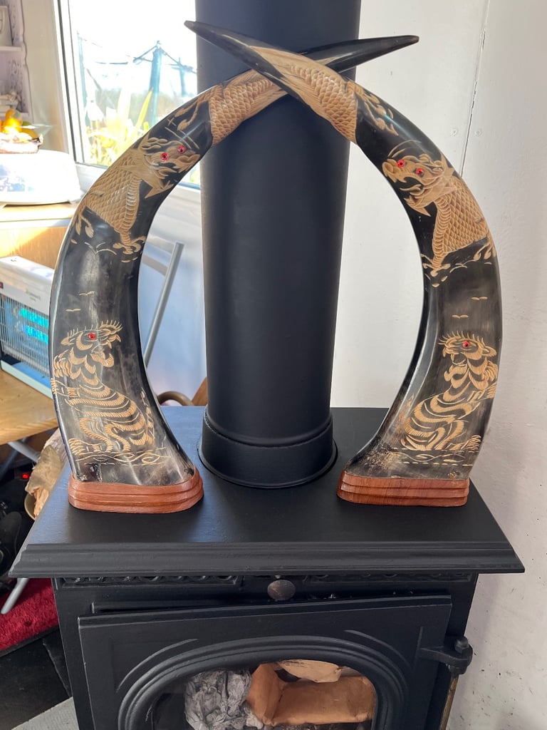A pair of carved Japanese style horns 