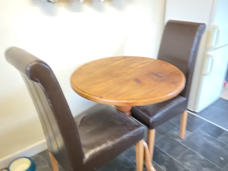 image for Round pine table and two upholstered dining chairs