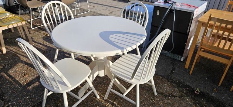 White farmhouse style round table and 4 chairs