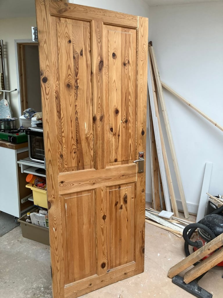 solid pine 4 panel door with silver coloured handle 