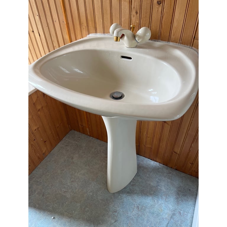 Beige coloured sink and taps 