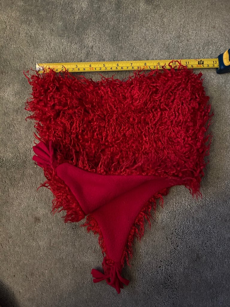 Red fuzzy fleece hat with tassels. .  