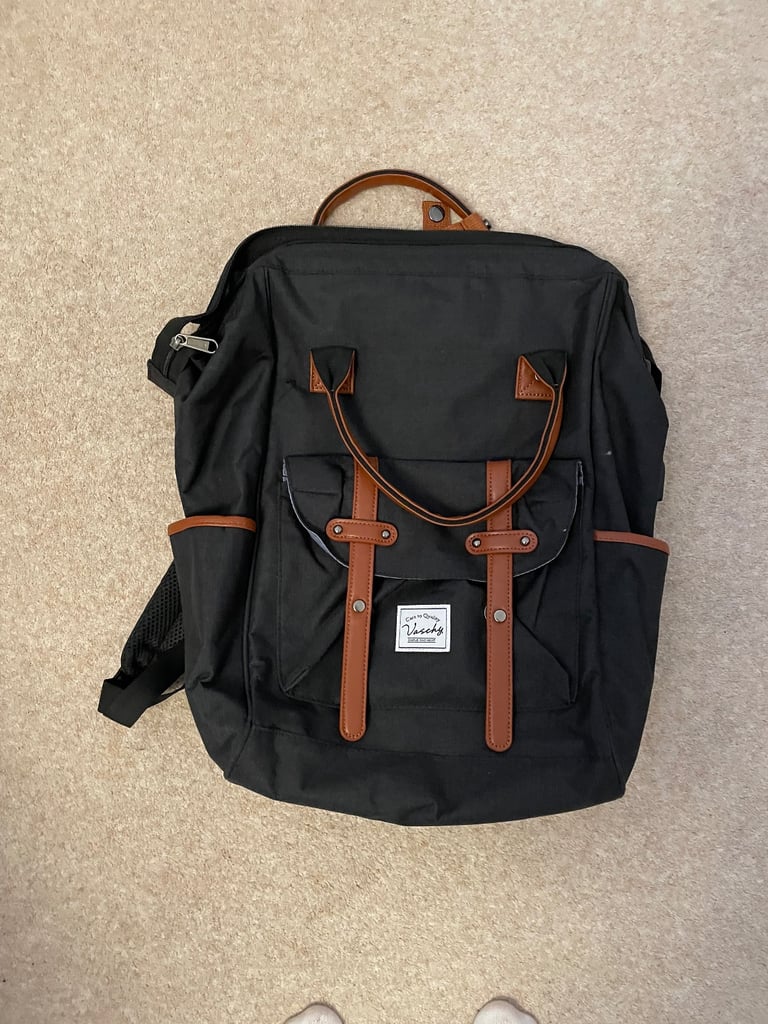 image for Waterproof black backpack with brown handles etc