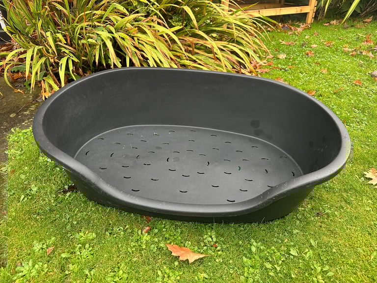 Large black plastic dog bed