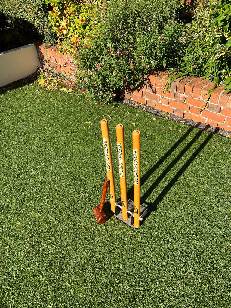 Spring back Kookaburra cricket stumps with cast iron base and a bat mallet