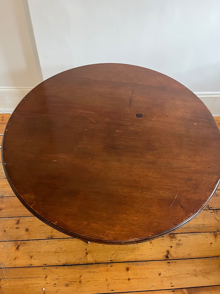 oval antique dining table on tripod leg