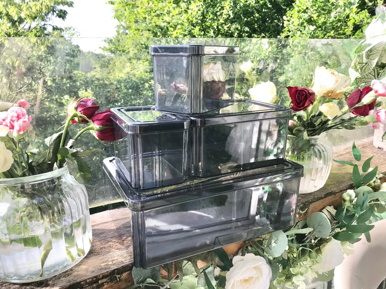 Good quality. Set of 4 Black tint plastic storage boxes Only used a few times
