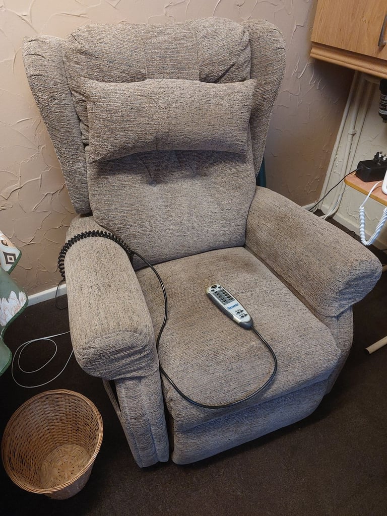 Electric sit/stand chair with heat and massage facility