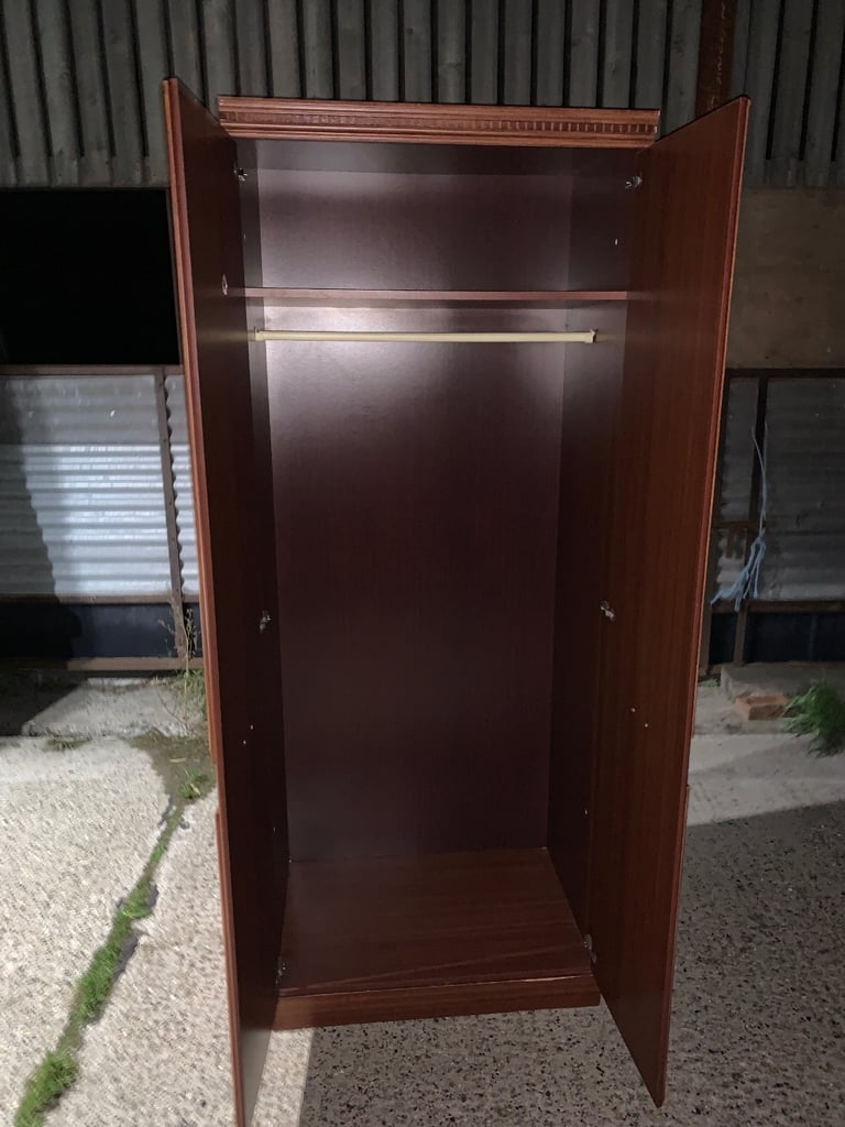 Elegant wooden wardrobe with decorative handles.