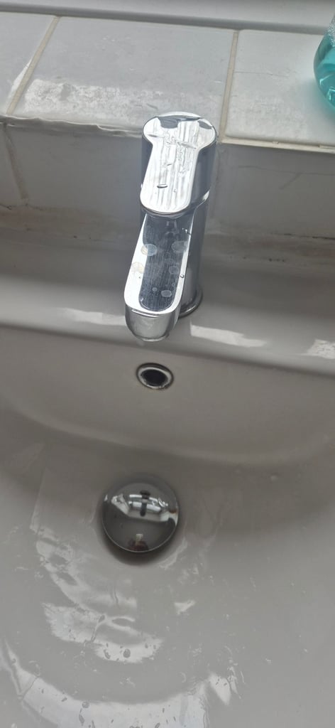 Basin with mixer tap .