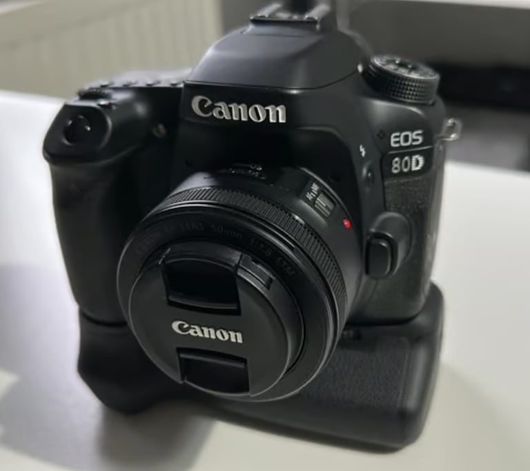 Canon EOS 80D camera with battery grip and lens