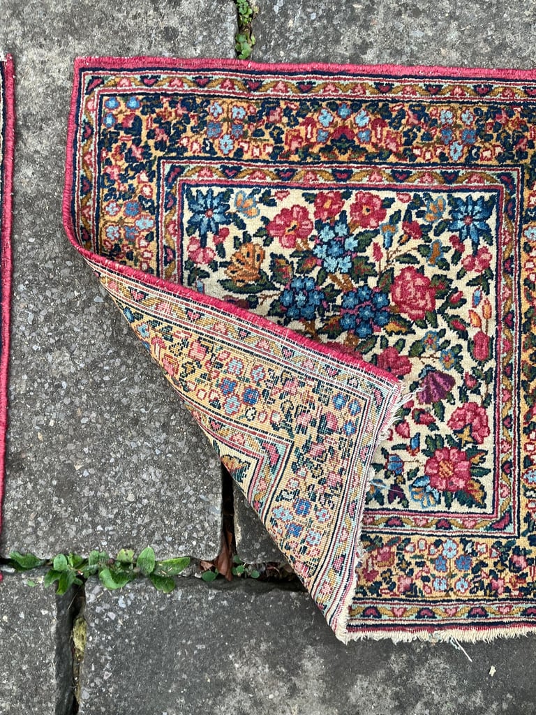 A pair of Antique Kirman mats 