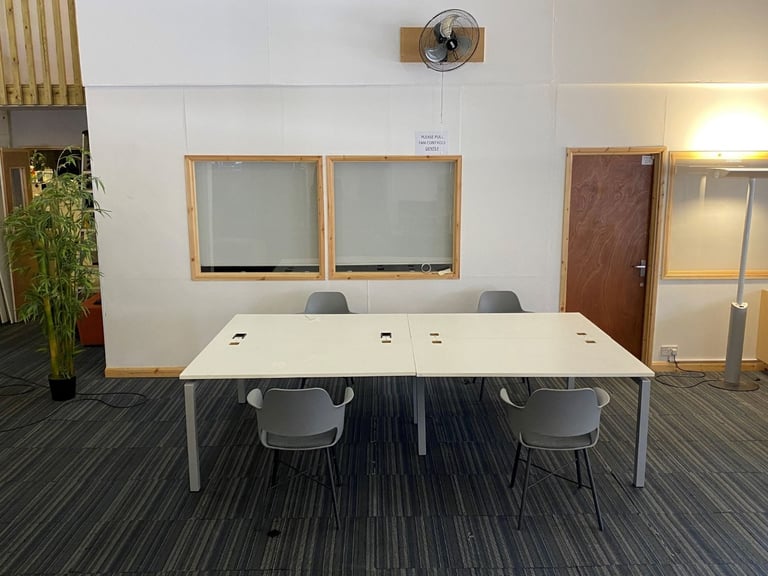 White bank of 4 used office bench desks 1400mm per desk