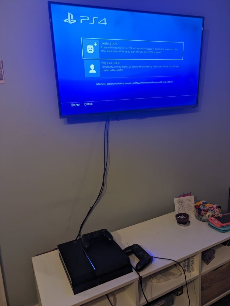 PlayStation 4 console and two controllers 