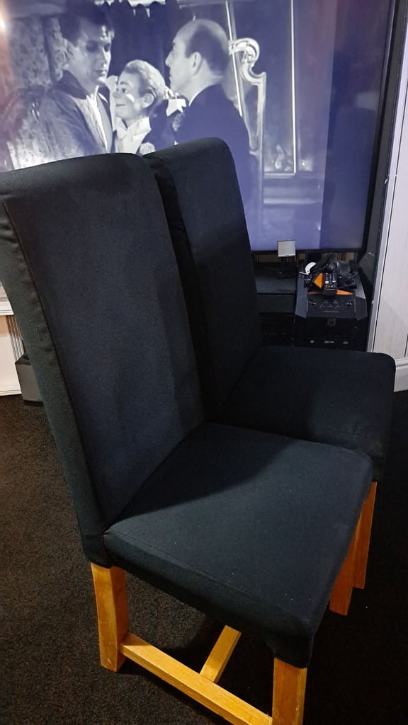 Two black solid chairs. 