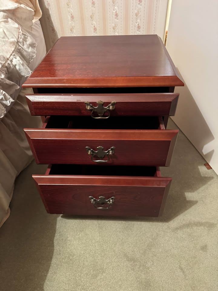 2 matching Mahogany Effect Bedside Tables with 2 drawers and a pull-out table with glass top.