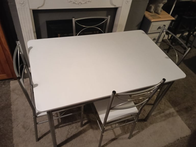 White dining table and four chairs feel free to contact me 