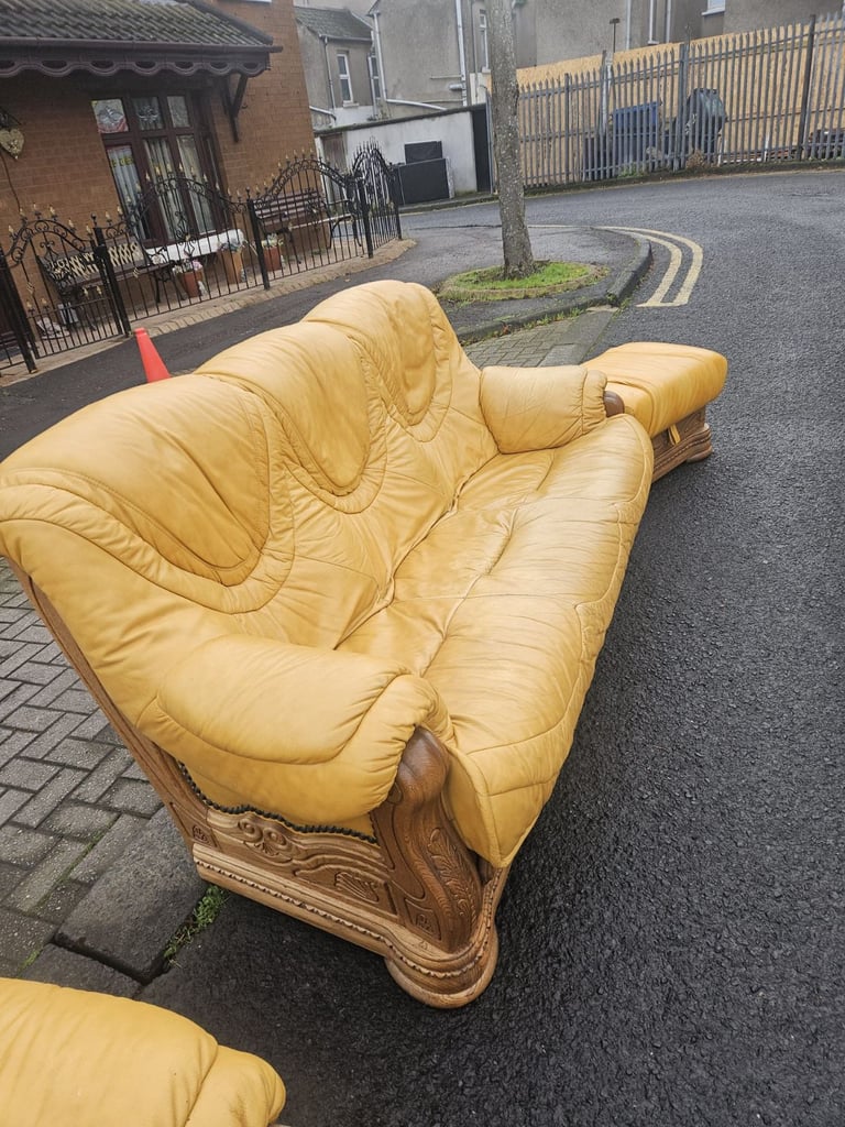 Leather sofa in soild oak inset with matching footstool 