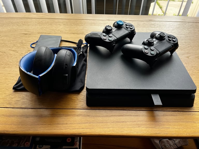 PS4 500GB, 1TB Game Drive, Headphones, Steering wheel with pedals and stand. 11 Games